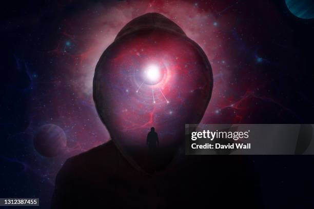 a science fiction concept of a hooded figure without a face. over layered with a man looking into a universe of stars and planets. - fantasy door stock pictures, royalty-free photos & images