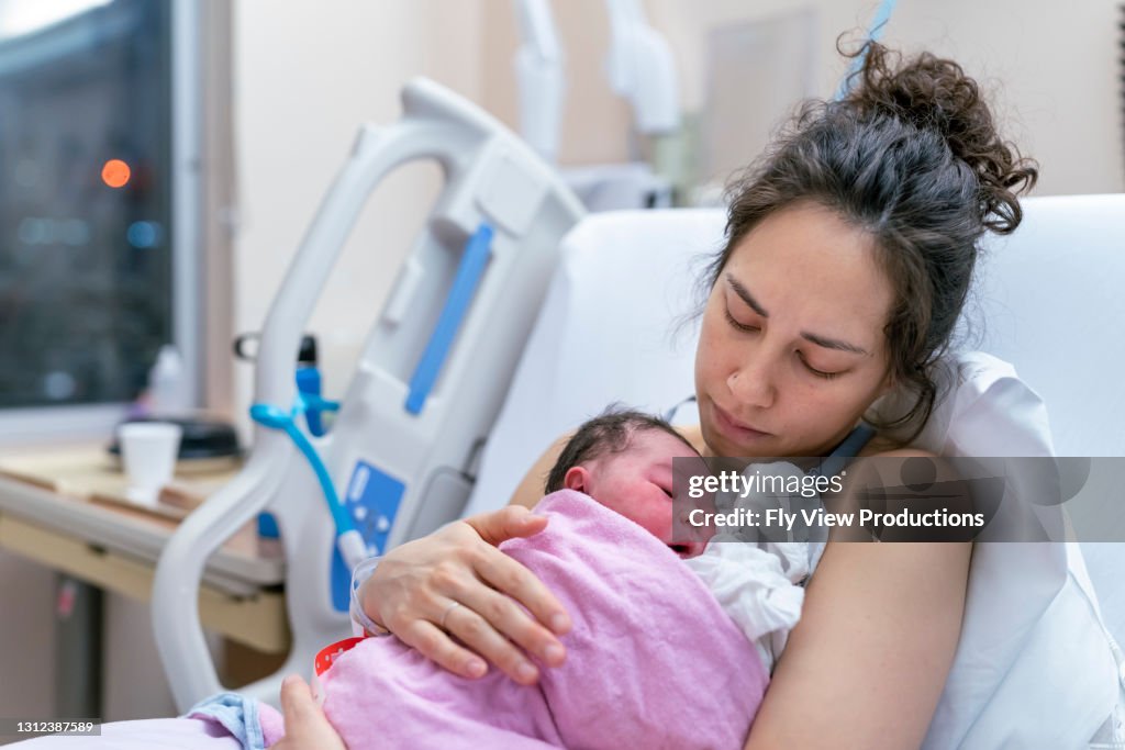 Gemengde Rasmoeder snuggling Pasgeboren na levering