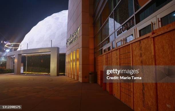 An entrance is boarded up next to the famed Cinerama Dome at the shuttered ArcLight Hollywood movie theater on April 13, 2021 in Los Angeles,...