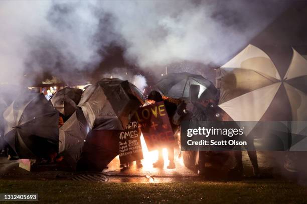 Demonstrators protesting the shooting death of Daunte Wright face off with police near the Brooklyn Center police station on April 13, 2021 in...