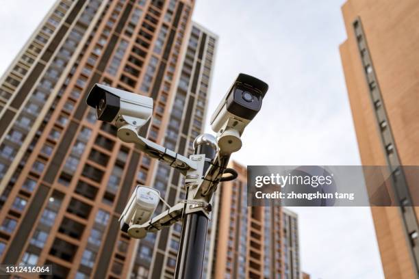 security camera against residential buildings background - security camera view stock pictures, royalty-free photos & images