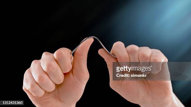 man's hands bending fork - bent stock pictures, royalty-free photos & images