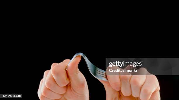 man's hands bending fork - bending stock pictures, royalty-free photos & images