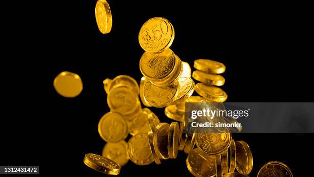 gold foil wrapped chocolate euro coins falling - cash falling stock pictures, royalty-free photos & images