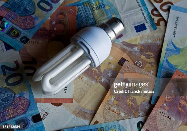 led bulb + euro banknotes - power of print media stock pictures, royalty-free photos & images