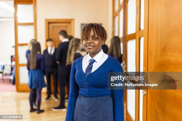 portrait of high school female student in front of the classroom. - african american school uniform stock pictures, royalty-free photos & images