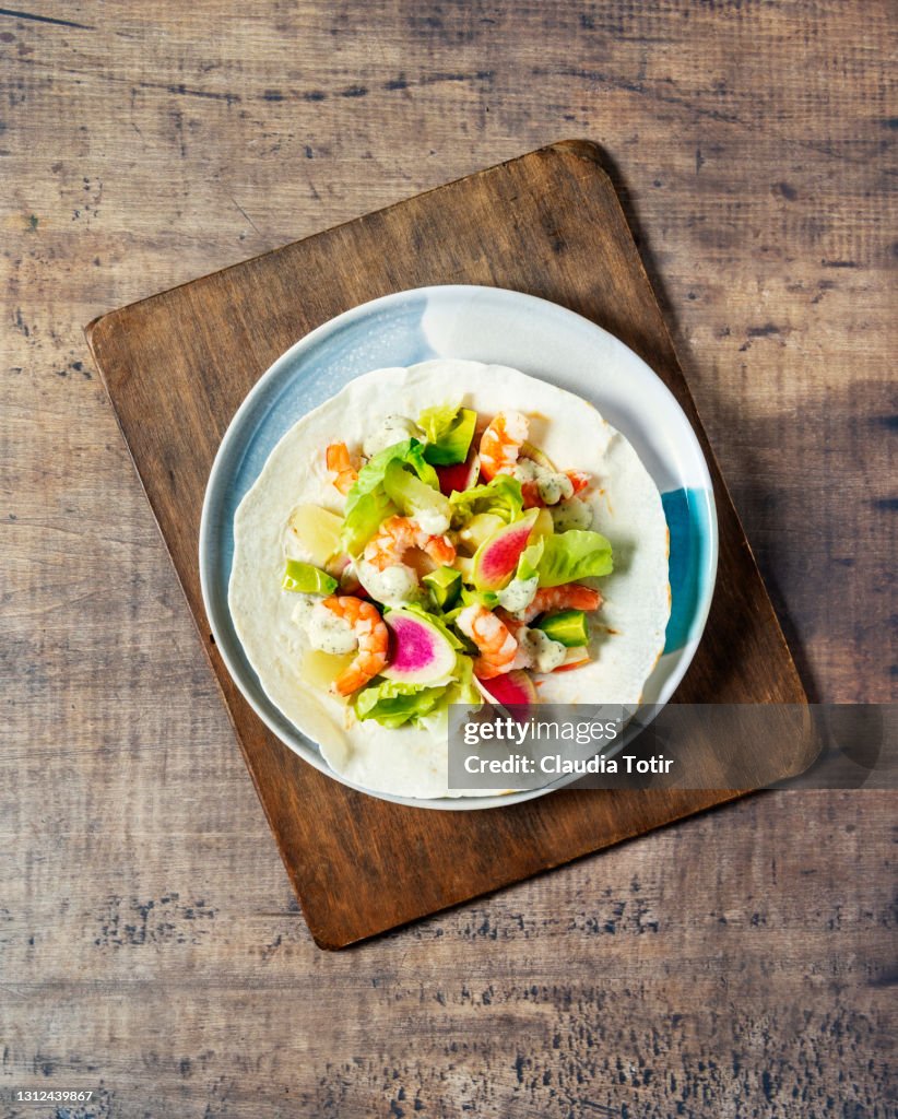 Shrimp tostada on wooden background