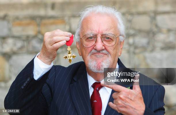 Bernard Cribbins poses with his Officer of the British Empire medal after receiving it during an Investiture ceremony with the Princess Anne,...