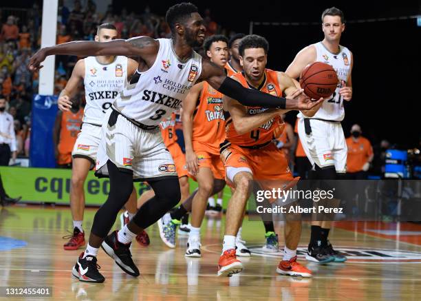 Tad Dufelmeier of the Taipans is pressured by Brandon Paul of the 36er during the round 14 NBL match between the Cairns Taipans and the Adelaide...