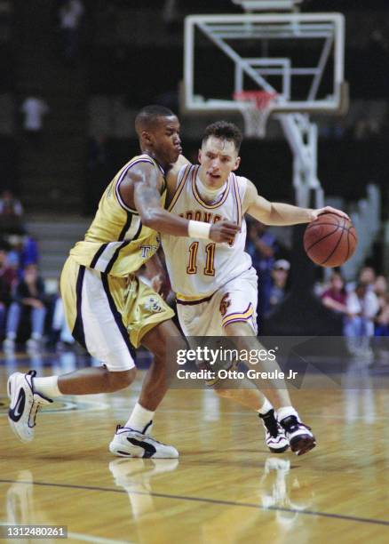 Steve Nash, Guard for the Santa Clara University Broncos dribbles the basketball around Stephon Marbury, Guard for the Georgia Tech Yellow Jackets...