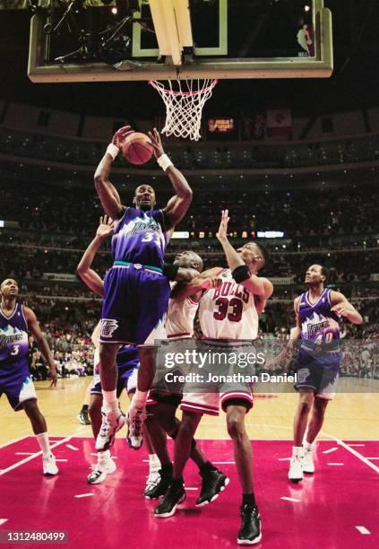 Karl Malone, Power Forward for the Utah Jazz jumps to reclaim the rebound basketball over Scottie Pippen of the Chicago Bulls during Game 5 of the...