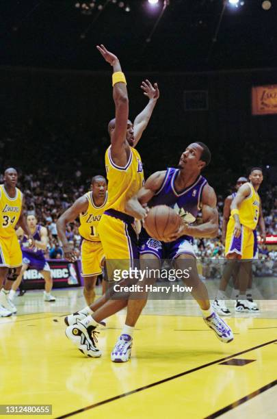 Shandon Anderson, Shooting Guard and Small Forward for the Utah Jazz is blocked by Kobe Bryant of the Los Angeles Lakers during their NBA Pacific...