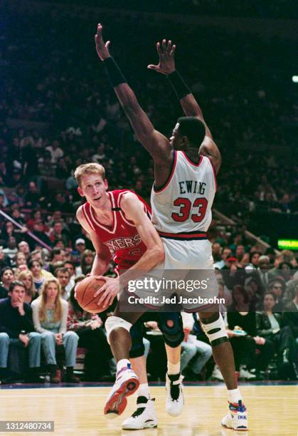 Shawn Bradley, Center for the Philadelphia 76ers attempts to move around the blocking efforts from Patrick Ewing of the New York Knicks during their...