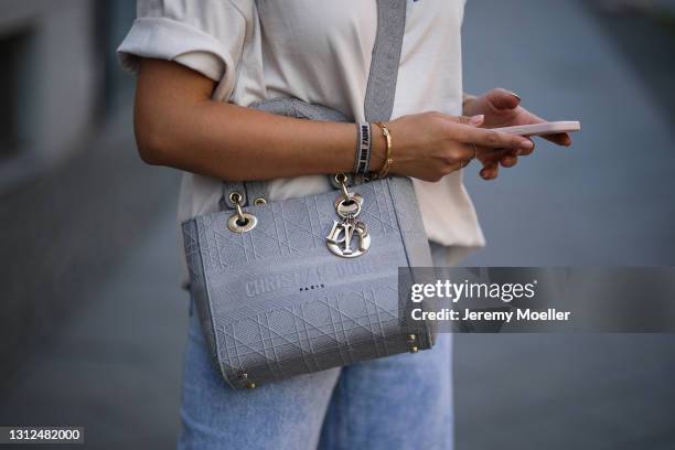 Catharina Maranca wearing beige Balenciaga shirt, Zara destroyed blue jeans and grey Lady Dior bag on April 11, 2021 in Berlin, Germany.