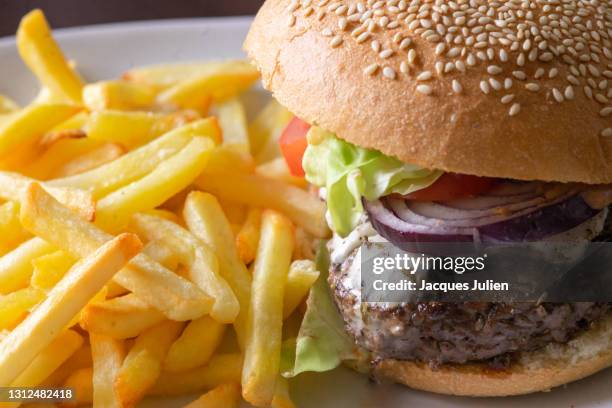 cheese burger and fries - burger onion stock-fotos und bilder