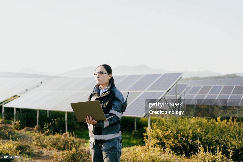 Asian female engineer working at solar power station
