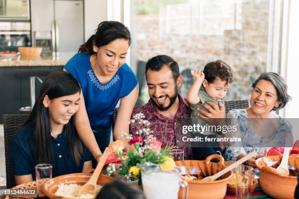 multi-generation family eating together outdoors - mexican food on table stock pictures, royalty-free photos & images