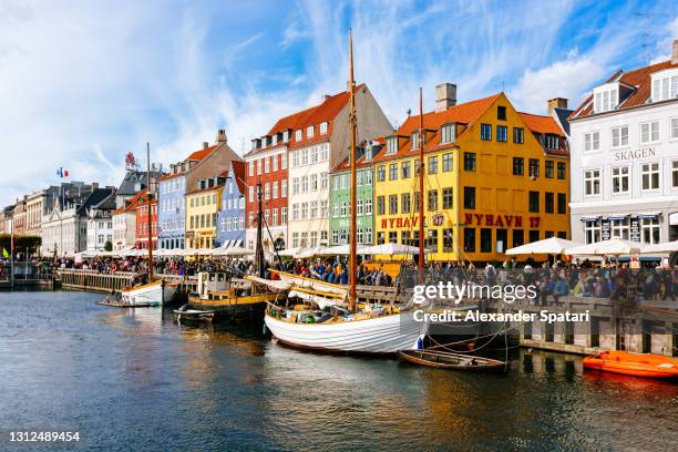 nuhavn harbor on a sunny day, copenhagen, denmark - copenhagen nyhavn stock pictures, royalty-free photos & images
