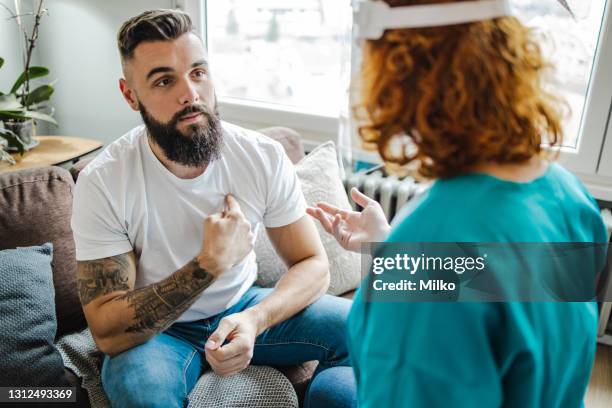 medical consultation with a home visiting nurse - stethoscope pills stock pictures, royalty-free photos & images