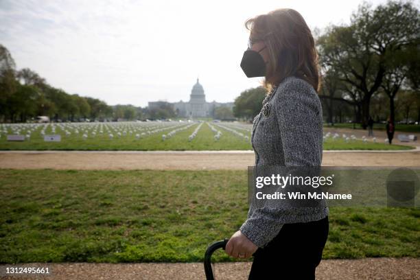 Former Rep. Gabby Giffords , who resigned from Congress due to a traumatic brain injury suffered during an assassination attempt, walks past an art...