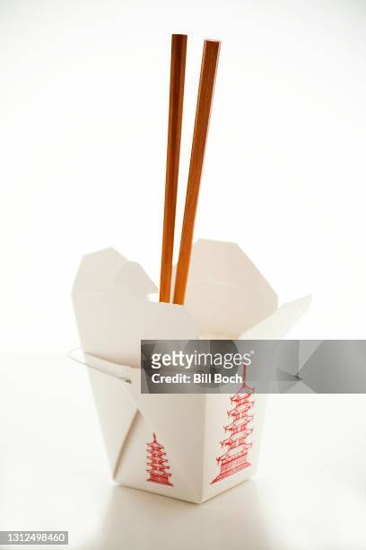 chinese food take out box with white rice and chopsticks sticking out of it, on a white background - chinese takeout white background stock pictures, royalty-free photos & images