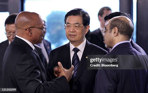 Jacob Zuma, South Africa's president, left, speaks with Hu Jintao, China's president, center, and Meles Zenawi, Ethiopia's prime minister, ahead of...