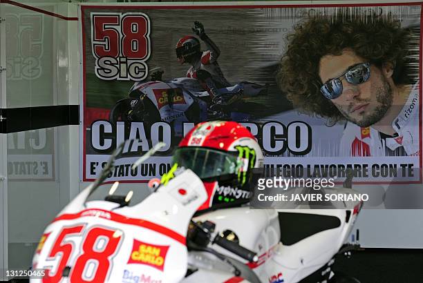 The helmet and the motorcycle of Italian MotoGP rider Marco Simoncelli are displayed as a tribute at Ricardo Tormo race track in Cheste near Valencia...