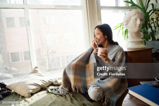 young asian woman in blue jeans - blanket stock pictures, royalty-free photos & images