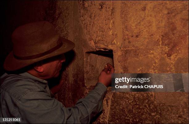 Egyptian Egyptologist Zahi Hawass, Secretary General of the Supreme Council of Antiquities in the Queen's chamber showing a vent through which the...