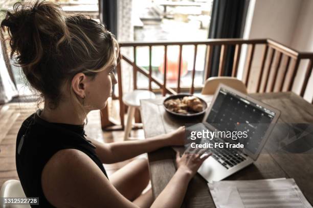 Young transgender woman using laptop working at home
