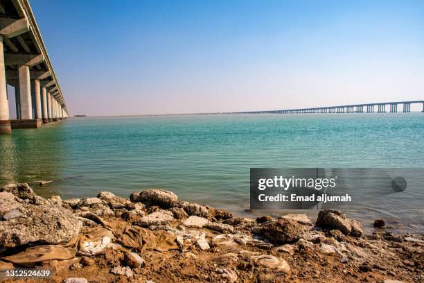 extensive bridge port of mubarak the great over turquoise water, kuwait city, kuwait - kuwait landscape stock pictures, royalty-free photos & images