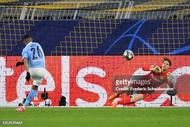 Riyad Mahrez of Manchester City scores their side's first goal past Marwin Hitz of Borussia Dortmund from the penalty spot during the UEFA Champions...