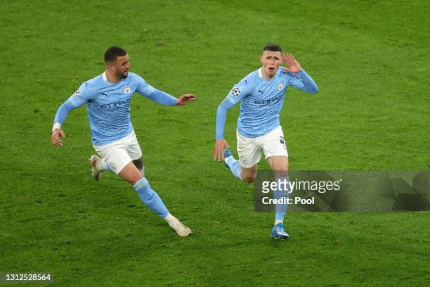 Phil Foden of Manchester City celebrates with team mate Kyle Walker after scoring their side's second goal during the UEFA Champions League Quarter...