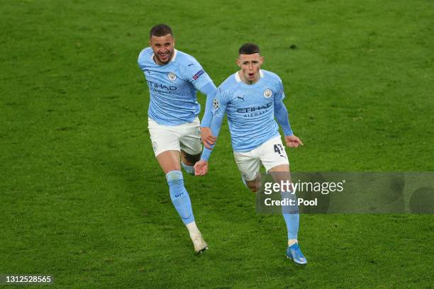 Phil Foden of Manchester City celebrates with team mate Kyle Walker after scoring their side's second goal during the UEFA Champions League Quarter...