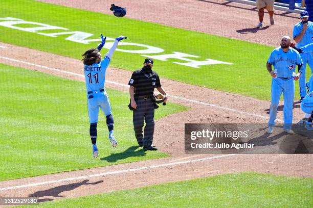 Bo Bichette of the Toronto Blue Jays tosses his helmet after hitting a walk-off home run in the ninth inning against the New York Yankees at TD...