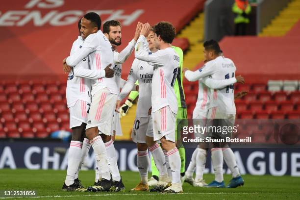 Eder Militao of Real Madrid celebrates victory with team mates following the UEFA Champions League Quarter Final Second Leg match between Liverpool...
