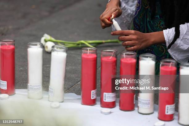 Candles are lit at a makeshift memorial during a vigil for Daunte Wright and Dominique Lucious at Washington Square Park in Manhattan on April 14,...