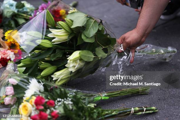 Flowers are placed at a makeshift memorial during a vigil for Daunte Wright and Dominique Lucious at Washington Square Park in Manhattan on April 14,...