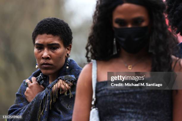 Imani, who chose not to disclose a last name, stands in silence at a makeshift memorial during a vigil for Daunte Wright and Dominique Lucious at...