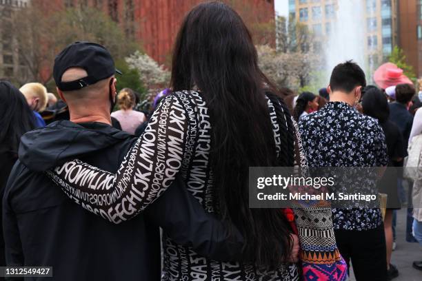 Couple embraces during a vigil for Daunte Wright and Dominique Lucious at Washington Square Park in Manhattan on April 14, 2021 in New York City. The...