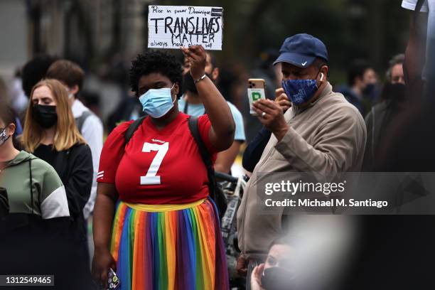 Woman holds up a sign during a vigil for Daunte Wright and Dominique Lucious at Washington Square Park in Manhattan on April 14, 2021 in New York...