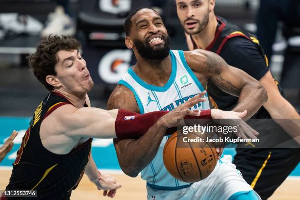 Brad Wanamaker of the Charlotte Hornets is fouled by Cedi Osman of the Cleveland Cavaliers in the third quarter during their game at Spectrum Center...