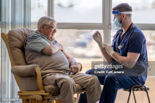 senior getting the covid-19 vaccine - aged care vaccine stock pictures, royalty-free photos & images