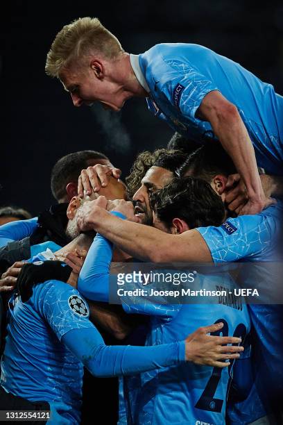 Oleksandr Zinchenko, Riyad Mahrez and Pep Guardiola, Manager of Manchester City celebrate after Phil Foden of Manchester City scores their side's...