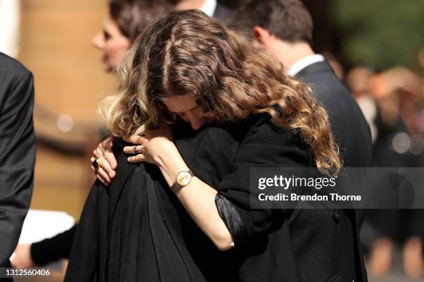 Bianca Spender, daughter of Carla Zampatti, hugs a mourner following the State Funeral for Carla Zampatti at St Mary's Cathedral on April 15, 2021 in...