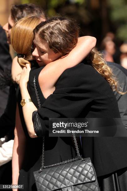 Bianca Spender, daughter of Carla Zampatti, hugs a mourner following the State Funeral for Carla Zampatti at St Mary's Cathedral on April 15, 2021 in...