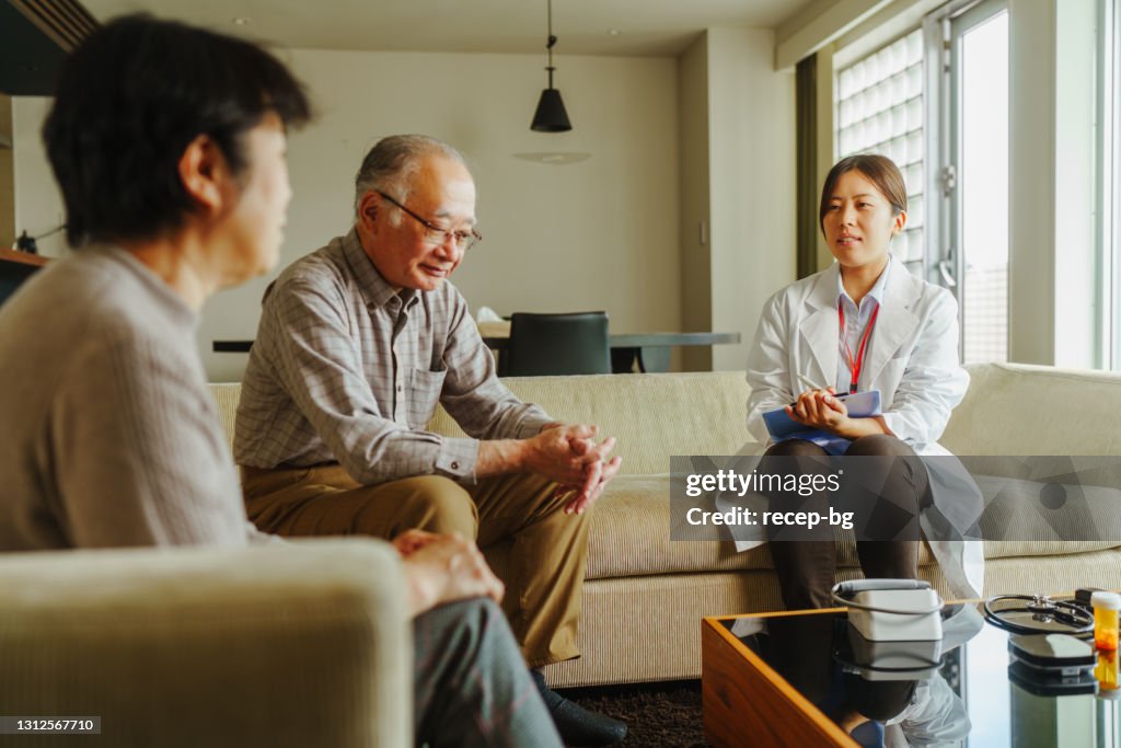 Female doctor home visiting senior patients at their home