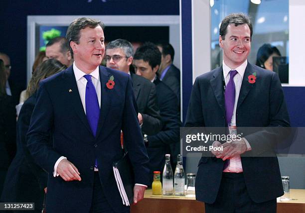 British Prime Minister David Cameron and British Chancellor of the Exchequer George Osborne talk before the first working session at the Group of 20...