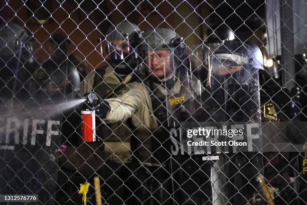 Police shoot pepper spray at demonstrators during a protest outside of the Brooklyn Center police station on April 14, 2021 in Brooklyn Center,...