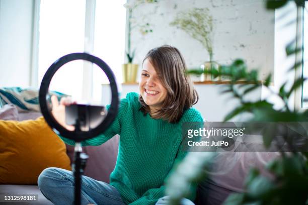 young influencer woman streaming live video with smartphone and led - content stock pictures, royalty-free photos & images